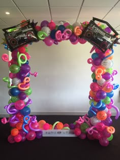 an arch made out of balloons and toys