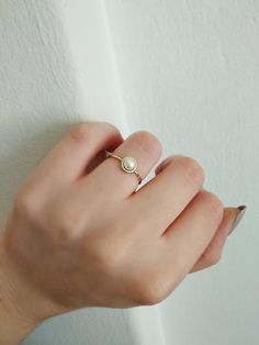 14K 9K Gold Solitaire Pearl Ring, Minimalist pearl ring, Dainty pearl ring, Stacking ring, Promise ring, Engagement ring, Gift for her, 14K Rose gold ring, Gift for her, Anniversary ring, FREE EXPRESS SHIPPING Beautiful and delicate white pearl ring made in 14K or 9K solid gold. The pearl is natural and not colored. Whisper...Always on trend! ;) -------------------------------------------------- D E T A I L S 14K or 9K Solid Gold Natural White Pearl 5mm Band width 1.4mm ------------------------- Everyday Pearl Ring With Charm, Minimalist Pearl Drop Ring For Gift, Minimalist Pearl Drop Rings As Gift, Minimalist Pearl Drop Ring For Promise, Pearl White Dainty Rings With Pearl Charm, Minimalist Pearl Charm Promise Ring, Minimalist Pearl Rings With Pearl Charm, Dainty Rings With Pearl Charm For Promise, Minimalist Pearl Charm Rings For Anniversary