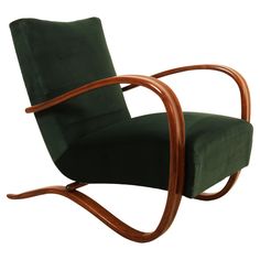 a wooden chair with green fabric on it's back and arm rests in front of a white background