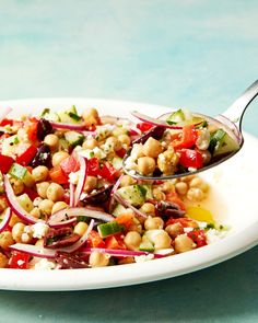 a white plate topped with a salad and a spoon