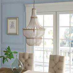 a dining room table with chairs and a chandelier