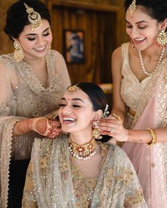 the bride is getting ready for her big day with friends and family onlookers