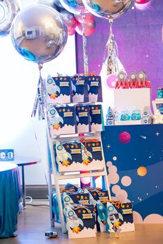 a space themed birthday party with balloons and decorations