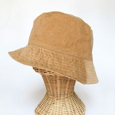 "The perfect weekend bucket hat! Made from 100% cotton tan corduroy makes this hat very comfortable to wear. A great sun hat for women, men, kids and babies. I made this hat with a day of adventure in mind, somewhere sunny and wild! This hat is made from a tan 100% cotton corduroy fabric. Inside liner is white cotton. Brim measures approx. 2.5\" wide. Crown measures approx. 3.5\" deep. Available in sizes: 0-3 mos. - 12\" to 14\" head circumference 3-6 mos. - 14\" to 16\" head circumference 6-12 Brown Cotton Bucket Hat With Short Brim, Adjustable Corduroy Hat For Everyday, Adjustable Natural Bucket Hat, Adjustable Natural Color Bucket Hat, Brown Cotton Bucket Hat With Curved Brim, Brown Brimmed Cotton Bucket Hat, Adjustable Corduroy Bucket Hat, Adjustable Brown Bucket Hat For Everyday, Corduroy Hat With Curved Brim For Spring