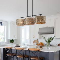 a kitchen with an island and stools in it