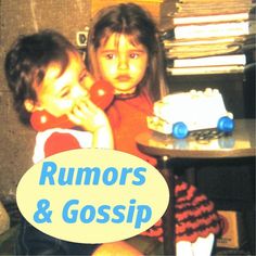 two young children sitting next to each other in front of a table with a cake on it