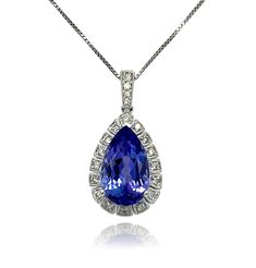 This stunning solitaire tear drop AAA quality Tanzanite pendant is surrounded by top quality shimmering brilliant cut diamonds. Comes with a gold chain. Pendant is brand new with tags attached. It comes in a beautiful box ready for the perfect gift! 18KW:          2.10 gms Tanz wt:      3.81 cts Tanz stones:  1 pear shape, 14x8 mm Diam wt:       0.16 cts Diam stones: 20 round brilliant cut diamonds, Color: H, Clarity: SI Free shipping within the US! Usually ships within 1-2 business days Retail value: $5975 Gold Chain Pendant, Tanzanite Pendant, Halo Earrings Studs, Halo Pendant, Chain Pendant, Diamond Halo, Red Garnet, Tear Drop, Round Brilliant Cut Diamond