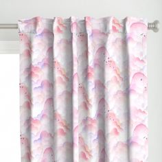 a window curtain with pink and purple clouds on it