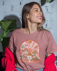 Retro aesthetic sunshine background with mushrooms, butterflies and flowers. This t-shirt is everything you've dreamed of and more. It feels soft and lightweight, with the right amount of stretch. It's comfortable and flattering for all.  *For oversized, relaxed look, size up to your preference. For actual sizing, refer to the size chart. * 100% combed and ring-spun cotton (Heather colors contain polyester) * Fabric weight: 4.2 oz/yd² (142 g/m²) * Pre-shrunk fabric * Side-seamed construction * Shoulder-to-shoulder taping * Blank product sourced from Guatemala, Nicaragua, Mexico, Honduras, or the US This product is made especially for you as soon as you place an order, which is why it takes us a bit longer to deliver it to you. Making products on demand instead of in bulk helps reduce overp 70's Aesthetic, Aesthetic Mushroom, 70s Aesthetic, Botanical Shirt, Butterfly Shirts, Groovy Retro, Retro Aesthetic, Retro Floral, Hippie Style