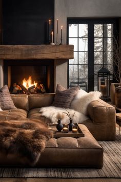 a living room filled with furniture and a fire place in the middle of the room