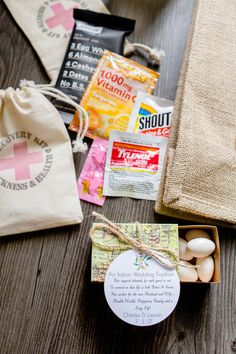 the contents of a bag are laid out on top of a wooden table, including an egg and candy bar