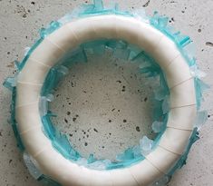 a white and blue wreath sitting on top of a cement floor