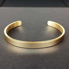 Embrace the Viking tradition of adornment with our Men's Gold Cuff Bracelet, a classic yet modern representation of Norse metalwork. Crafted from high-quality stainless steel, this bracelet reflects the Viking passion for decoration in every aspect of life. Its sleek gold finish offers a contemporary twist to traditional Viking aesthetics, making it a perfect accessory for those who value both history and modern style. - Material: Stainless Steel - Rust, scratch and tarnish resistant; hypoallerg Shiny Metal Bangle Bracelets, Metal Bangle Bracelet With Shiny Finish, Metal Bangle Bracelets With Shiny Finish, Adjustable Shiny Finish Bangle Bracelet, Classic Metal Cuff Bracelet, Classic Metal Cuff Bracelets, Classic Metal Bangle With Jubilee Bracelet, Modern Metal Wristband As Gift, Modern Metal Wristband Gift