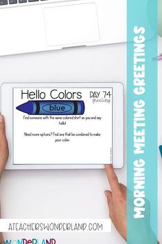 two hands holding an ipad with the words hello colors day 7 on it and next to them is a keyboard, mouse, pens, and laptop