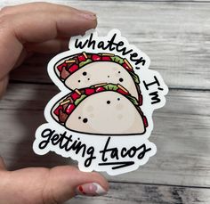 someone holding up a sticker that says, whatever i'm getting taco