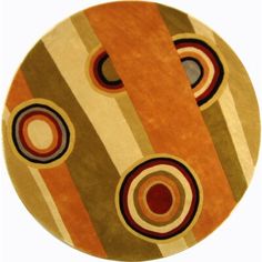 a round rug with circles and stripes on the bottom in orange, brown, beige and black colors