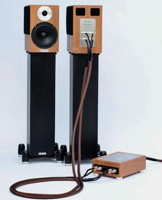 an electronic device is plugged in to two speaker stands with wires running through them