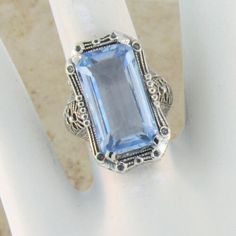 Vintage Estate 8 Carat Simulated Aquamarine Filigree Ring. Floral Details. 925 Solid Sterling Silver. Stamped 925. Excellent Condition. Like New. Silver Rectangular Sapphire Ring, Formal Silver Engraved Ring With Gemstone, Silver Engraved Ring With Gemstone For Formal Occasions, Collectible Silver Jewelry With Accent Stones, Vintage Silver Hallmarked Topaz Ring, Formal Sterling Silver Engraved Ring With Gemstone, Vintage Sterling Silver Topaz Collectible Ring, Vintage Sterling Silver Topaz Promise Ring, Formal Emerald Cut Jewelry Stamped 925