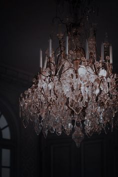 a chandelier hanging from the ceiling in a dark room