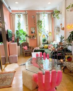 a living room filled with furniture and lots of plants