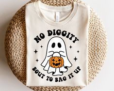 a white t - shirt with a ghost holding a pumpkin