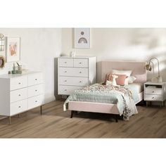 a bedroom with white furniture and wood flooring, including a bed, dresser, mirror and chest of drawers