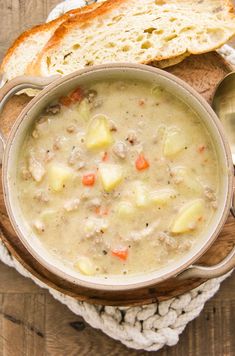 a bowl of soup with bread on the side