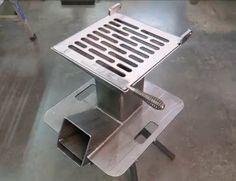 a metal grate sitting on top of a table in a room with no one around it