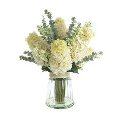 a vase filled with white flowers on top of a table