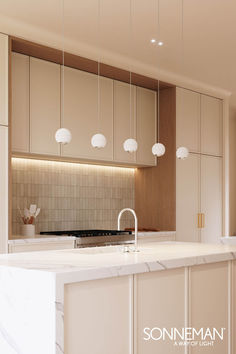 a kitchen with marble counter tops and hanging lights above the island, along with white cabinets