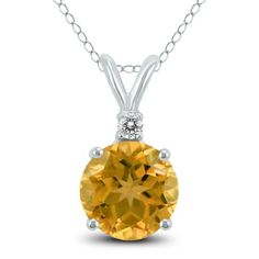 A beautiful 5mm round shaped citrine and diamond pendant necklace set in a 14K white gold basket setting. A single diamond weighs 0.02 carat. The pendant hangs from an 18 inch chain also crafted in 14K white gold. Round Topaz Necklace With Diamond Accents, Round Topaz Necklaces With Diamond Accents, Yellow Round Necklaces With Diamond Accents, Gold Basket, Diamond Pendants Designs, Diamond Pendants, Stylish Watches, Diamond Pendant Necklace, Pendant Design