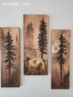 three wooden wall hangings with bear images on them