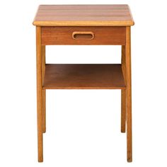 a small wooden table with one drawer on the top and two shelves below it, against a white background