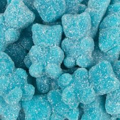 blue gummy bear candies are piled on top of each other in this close up photo