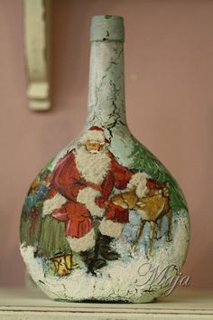 a santa clause painting on a vase sitting on a shelf next to a wall hook