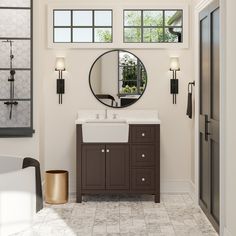 a bathroom with a sink, mirror and bathtub in the middle of the room