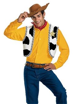 a man in a yellow shirt and cowboy hat is posing for the camera with his hands on his head