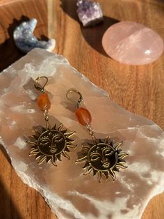 my favorite part of everyday is picking out a fun pair of earrings that describe your personality :) these sun charms are so fun and happy. rust agate crystal beads that were found at my local thrift store and wire wrapped by me. these two match together perfectly and are giving me sunset vibes Handmade Amber Agate Earrings, Bohemian Sun Design Adjustable Earrings, Handmade Adjustable Carnelian Earrings, Bohemian Gold Carnelian Earrings, Gold Bohemian Carnelian Earrings, Spiritual Handmade Agate Earrings, Bohemian Sun Shaped Jewelry Gift, Bohemian Amber Wire-wrapped Earrings, Bohemian Amber Wire Wrapped Earrings