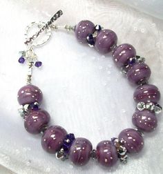 Purple Rain in a Lampwork Beaded Bracelet by Alliaks on Etsy, $85.00 Spiritual Beaded Jewelry For Anniversary, Hand-strung Silver Czech Glass Jewelry, Purple Rondelle Beaded Bracelets As Gift, Czech Glass Beaded Jewelry Gift, Handmade Rondelle Beaded Bracelets For Jewelry Making, Adjustable Czech Glass Bracelets As Gifts, Adjustable Czech Glass Bracelet As Gift, Adjustable Czech Glass Bracelets For Gifts, Gift Crystal Bracelet With Spacer Beads