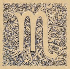 the letter m is made up of intricate designs