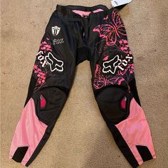 a pair of pink and black pants laying on the ground