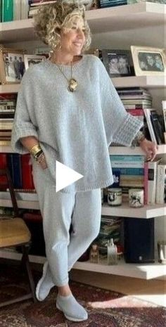 a woman standing in front of a book shelf