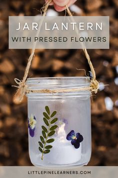 a jar with flowers painted on it and the words jar lantern with pressed flowers written below