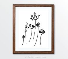 a black and white drawing of flowers in a wooden frame