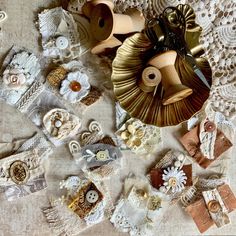 many different types of buttons and laces on a table cloth with doily around them