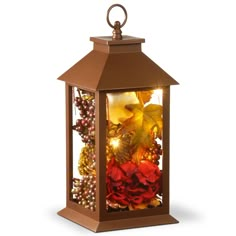 a lantern filled with lots of different types of flowers