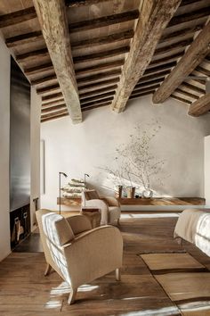 the bedroom is decorated in rustic style and has exposed wood beams on the ceiling, along with an upholstered bed