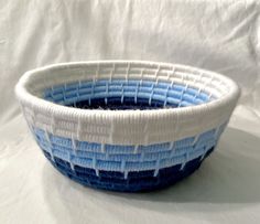 a blue and white basket sitting on top of a table