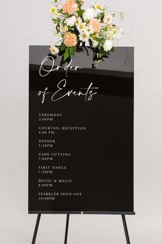 a black and white sign with flowers on it that says order of events in cursive writing