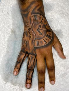 a man's hand with a clock tattoo on it